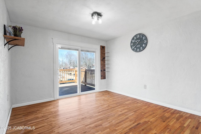 empty room featuring baseboards and wood finished floors