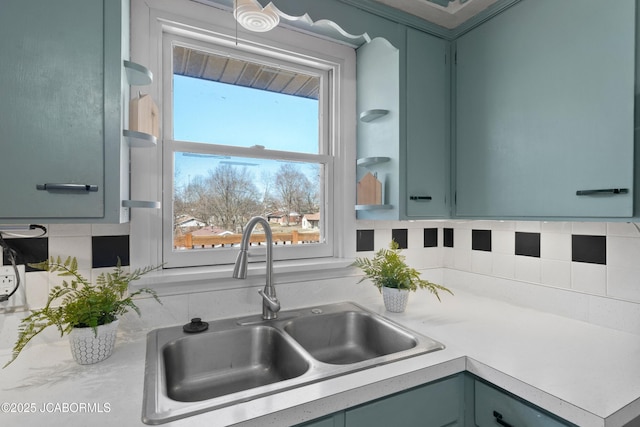 interior space with a sink, open shelves, and green cabinetry