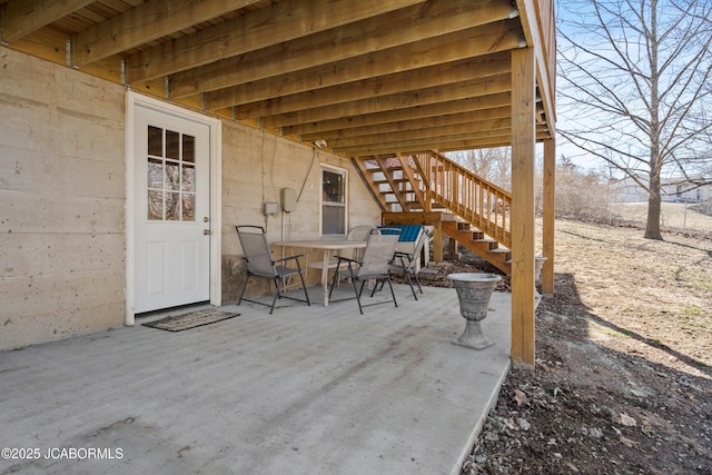 view of patio featuring stairway and outdoor dining space