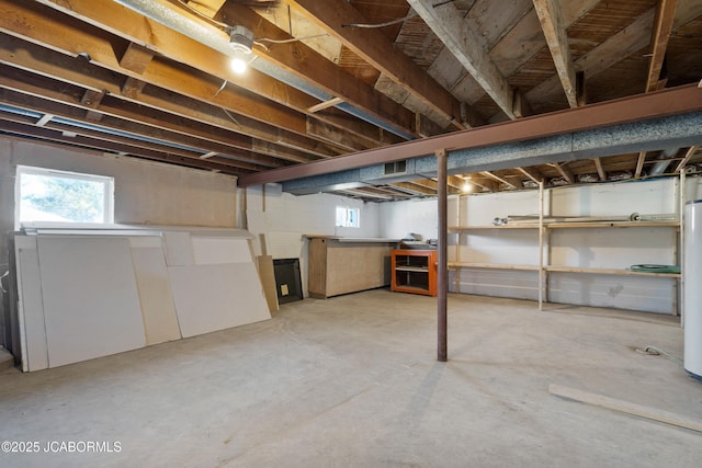 below grade area featuring water heater and a wealth of natural light