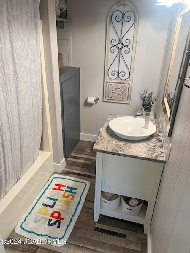 bathroom with vanity, shower / bath combo, and hardwood / wood-style flooring