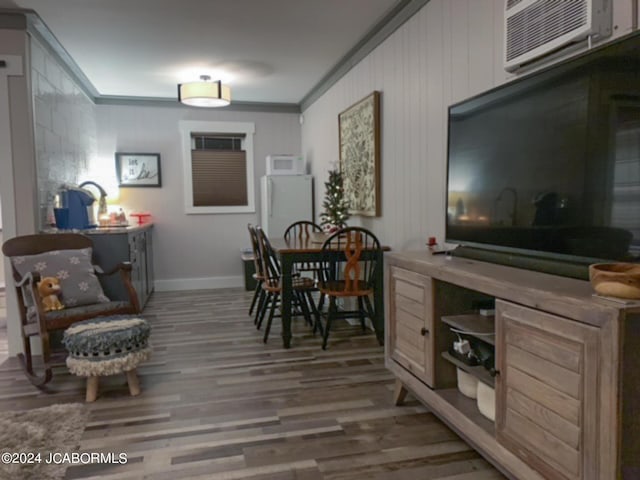 dining space with a wall unit AC, crown molding, and wood-type flooring