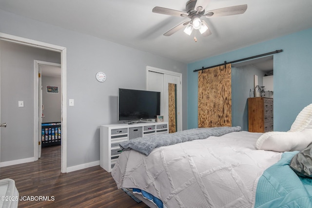 4758 Henwick Ln, Jefferson City, MO 65109 - bedroom featuring dark wood-type flooring, a barn door, a closet, and ceiling fan