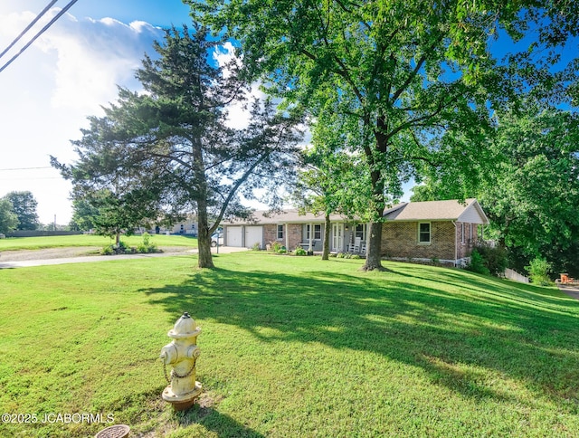 4758 Henwick Ln, Jefferson City, MO 65109 - view of grassy yard with an attached garage