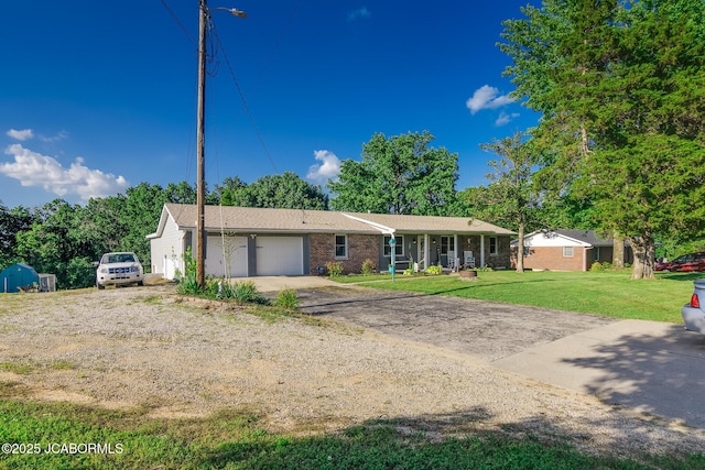 4758 Henwick Ln, Jefferson City, MO 65109 - ranch-style house featuring an attached garage, driveway, brick siding, and a front lawn