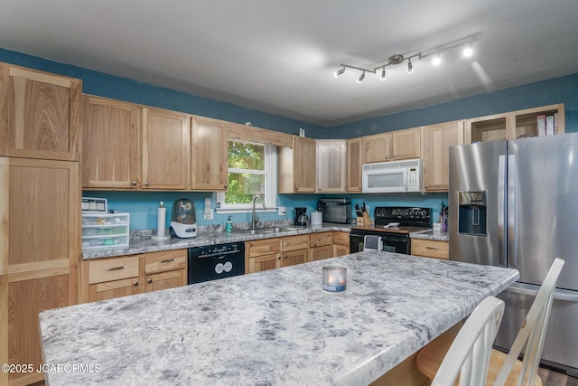 4758 Henwick Ln, Jefferson City, MO 65109 - kitchen with black appliances, light stone countertops, light brown cabinetry, a breakfast bar, and a center island