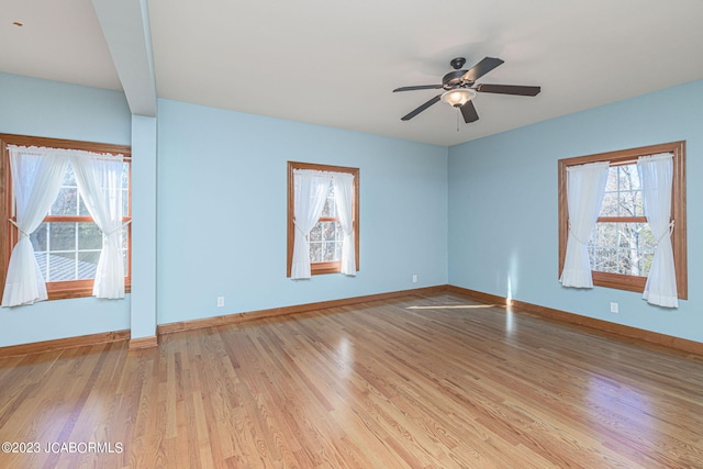 spare room with light wood-type flooring and ceiling fan