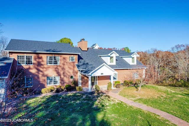 view of front of home featuring a front yard and a patio