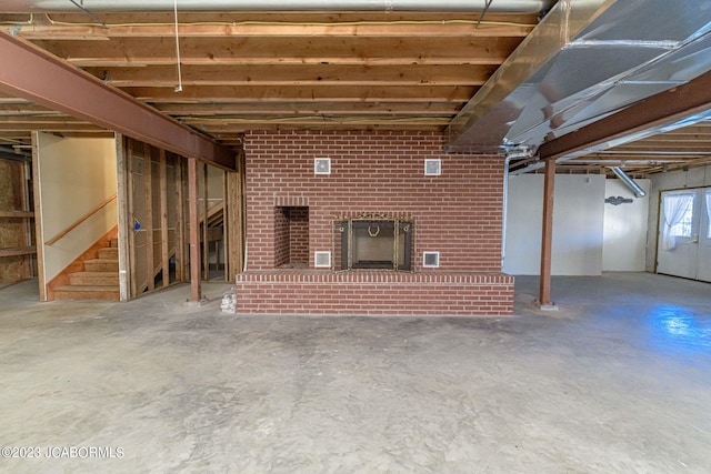 basement featuring a brick fireplace