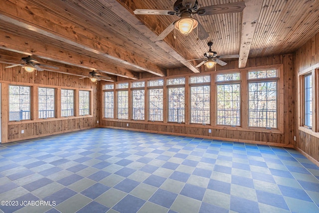 unfurnished sunroom featuring beam ceiling and wood ceiling