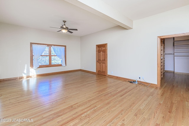 unfurnished living room featuring beamed ceiling, light wood-type flooring, and ceiling fan