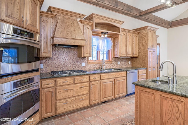 kitchen featuring beam ceiling, sink, stainless steel appliances, backsplash, and dark stone counters