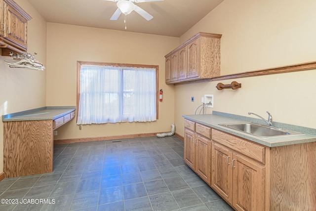 kitchen featuring ceiling fan and sink