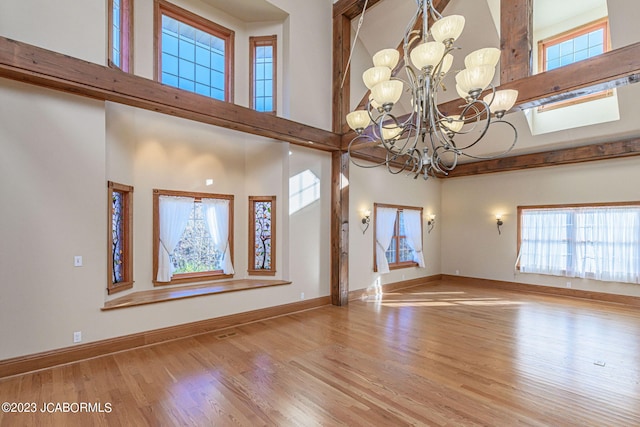 foyer entrance featuring light hardwood / wood-style flooring and an inviting chandelier