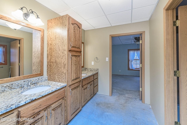 bathroom with vanity and a drop ceiling