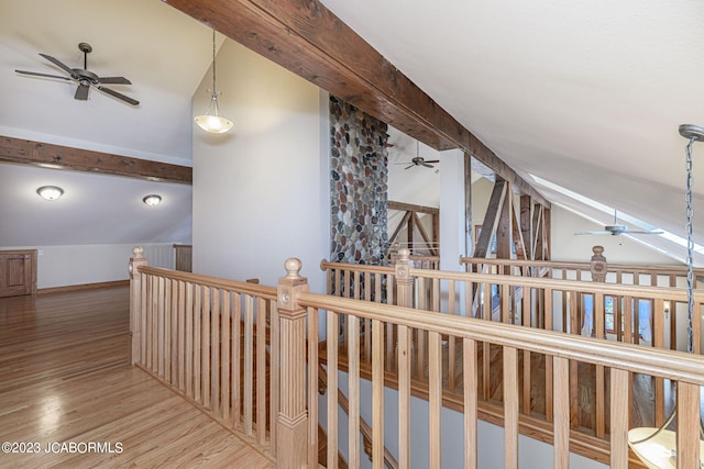 hallway with hardwood / wood-style floors and lofted ceiling with beams