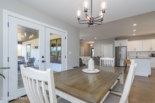 dining room with french doors, plenty of natural light, dark wood finished floors, and recessed lighting