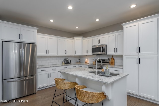 kitchen featuring dark wood-style floors, appliances with stainless steel finishes, and white cabinetry