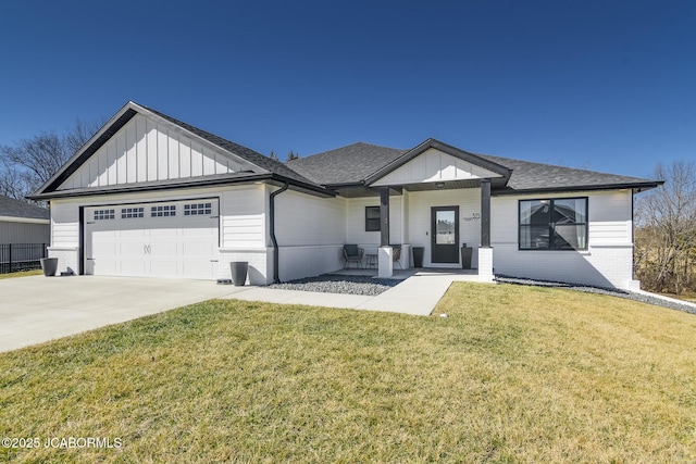 view of front of home with roof with shingles, concrete driveway, an attached garage, board and batten siding, and a front yard