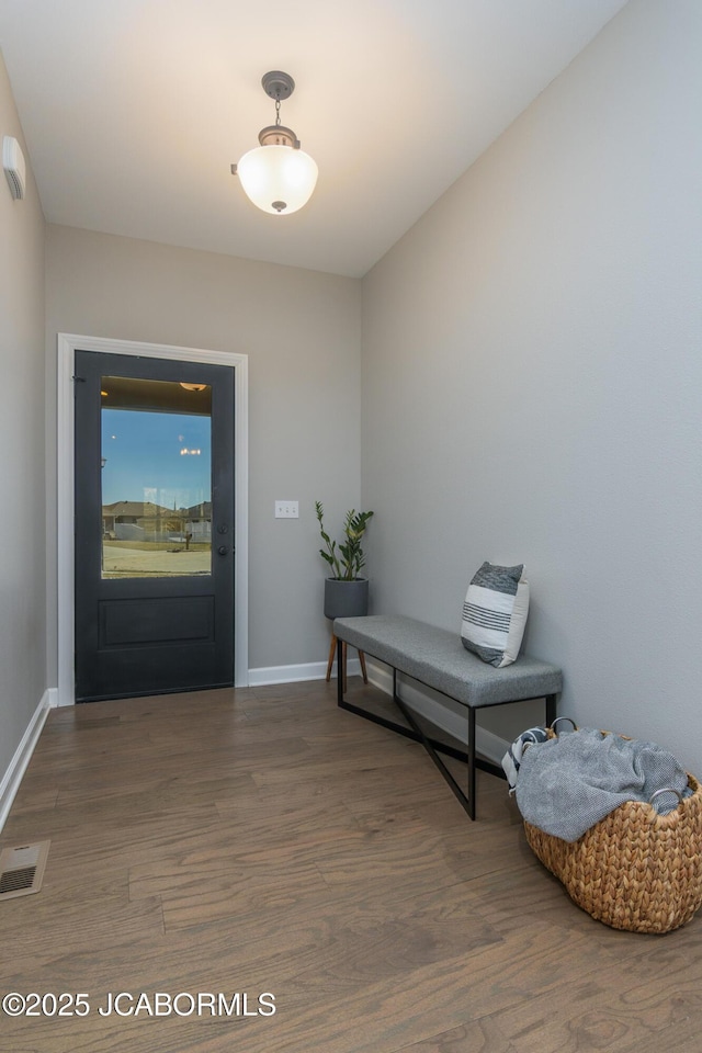 entrance foyer with baseboards, visible vents, and wood finished floors