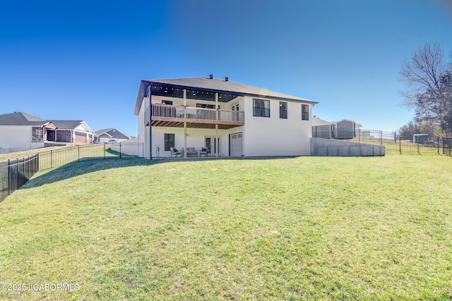 rear view of house featuring a yard, an attached garage, and a fenced backyard