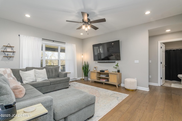 living area with a ceiling fan, baseboards, wood finished floors, and recessed lighting