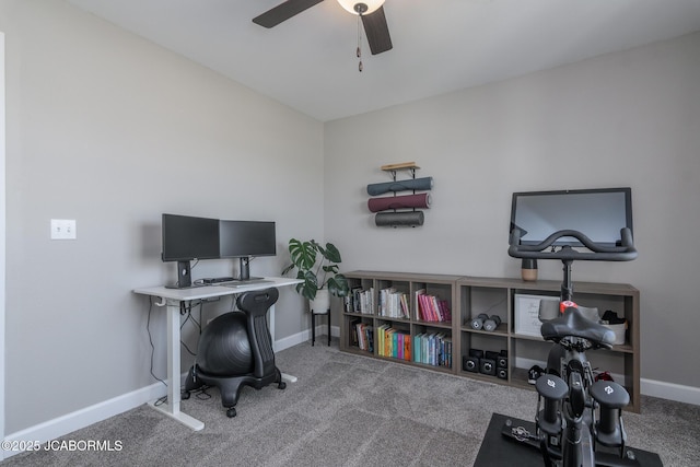 carpeted office space with ceiling fan and baseboards