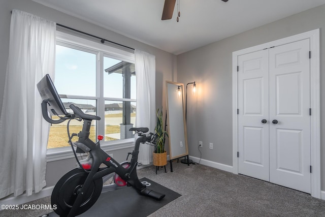 exercise room featuring a ceiling fan, carpet flooring, and baseboards