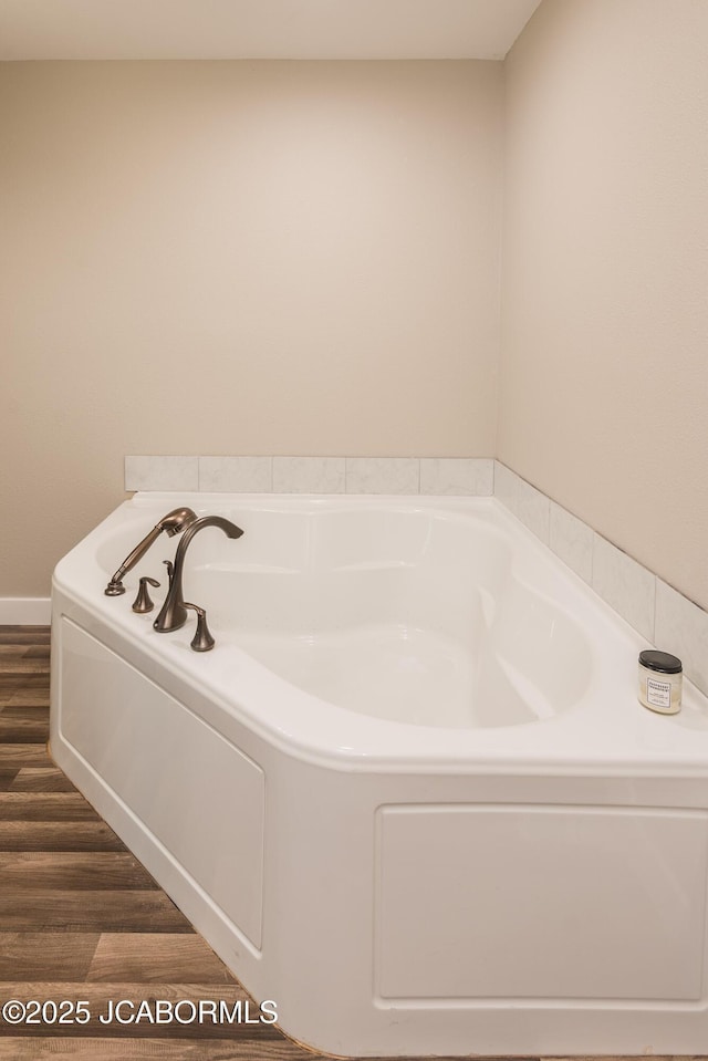 1811 W Main St, Jefferson City, MO 65109 - bathroom with a garden tub and wood finished floors