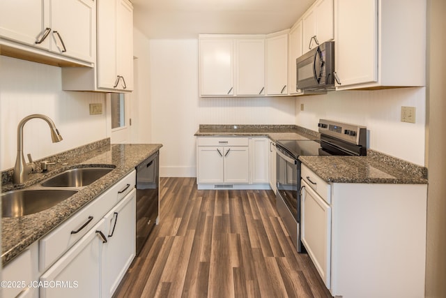 1811 W Main St, Jefferson City, MO 65109 - kitchen with black appliances, white cabinetry, dark wood finished floors, and dark stone countertops