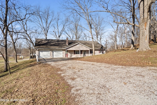 ranch-style house with a garage and a front lawn