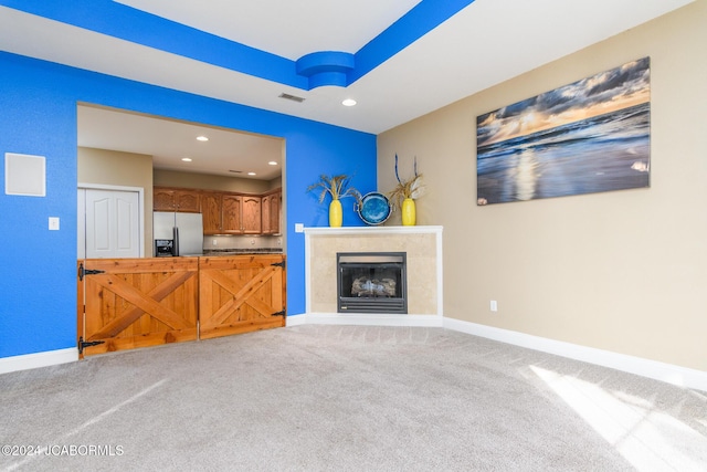 unfurnished living room featuring a fireplace and carpet flooring