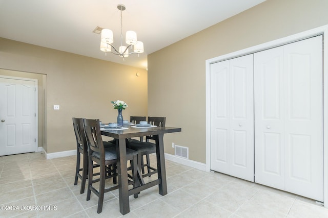 dining area featuring light tile patterned floors and a chandelier