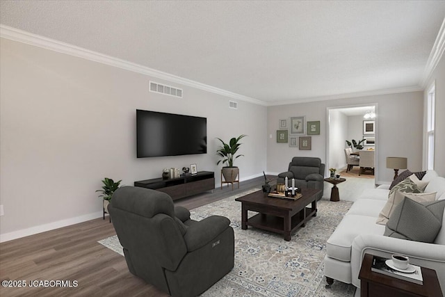 living room with crown molding, a textured ceiling, and hardwood / wood-style flooring