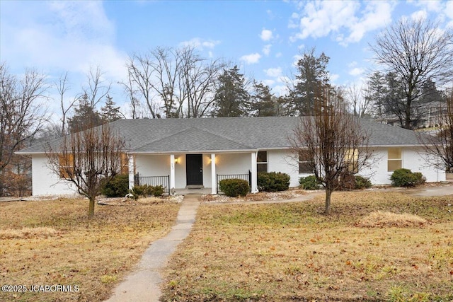 ranch-style home featuring a porch and a front lawn