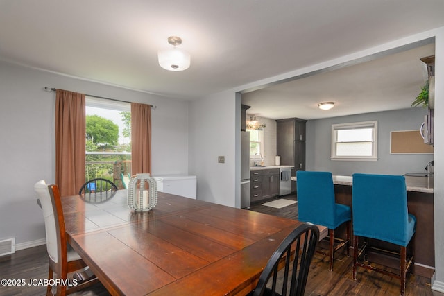 202 S Fourth St, Linn, MO 65051 - dining space with a wealth of natural light, dark wood-style flooring, and baseboards