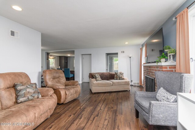 202 S Fourth St, Linn, MO 65051 - living area featuring visible vents, dark wood-style flooring, a brick fireplace, and recessed lighting