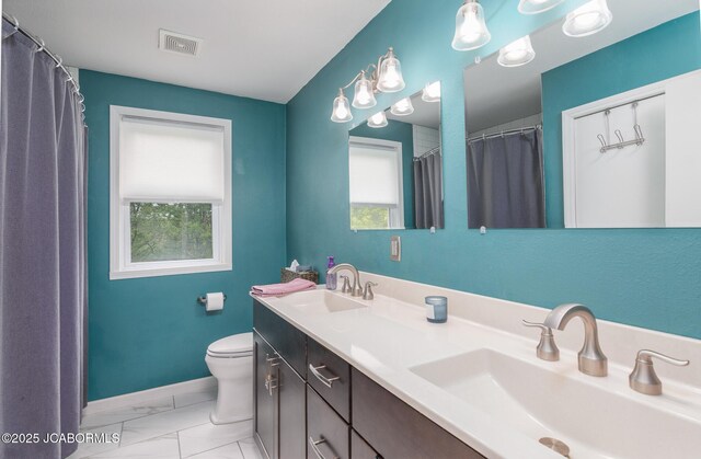 202 S Fourth St, Linn, MO 65051 - full bathroom featuring a sink, toilet, marble finish floor, and visible vents