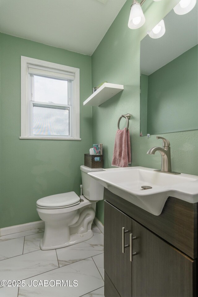 202 S Fourth St, Linn, MO 65051 - half bath featuring toilet, baseboards, vanity, and marble finish floor