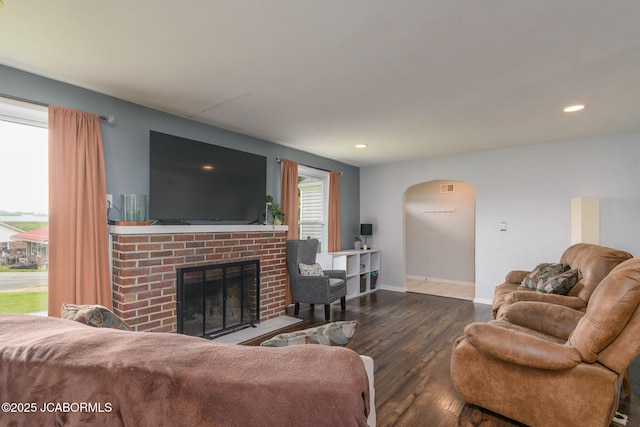 202 S Fourth St, Linn, MO 65051 - living room with arched walkways, a brick fireplace, recessed lighting, and wood finished floors