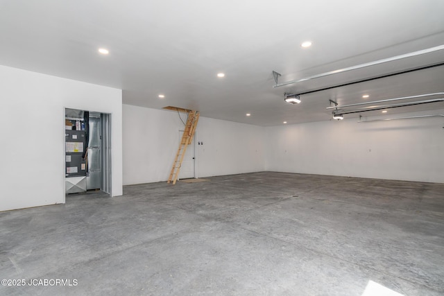 8206 Big Meadows Rd, Jefferson City, MO 65101 - garage featuring recessed lighting, a garage door opener, and heating unit