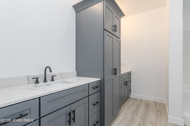 8206 Big Meadows Rd, Jefferson City, MO 65101 - full bath with wood finished floors, vanity, and baseboards