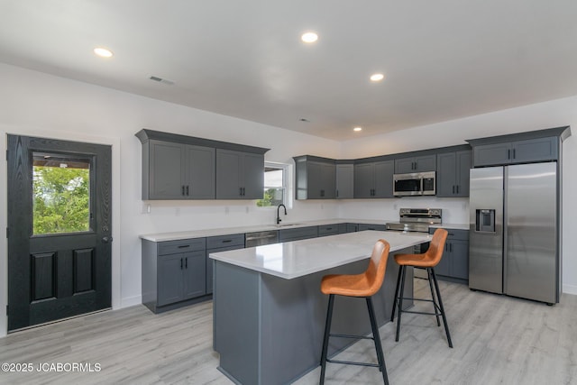 8206 Big Meadows Rd, Jefferson City, MO 65101 - kitchen featuring appliances with stainless steel finishes, light wood-style floors, a kitchen island, a sink, and recessed lighting