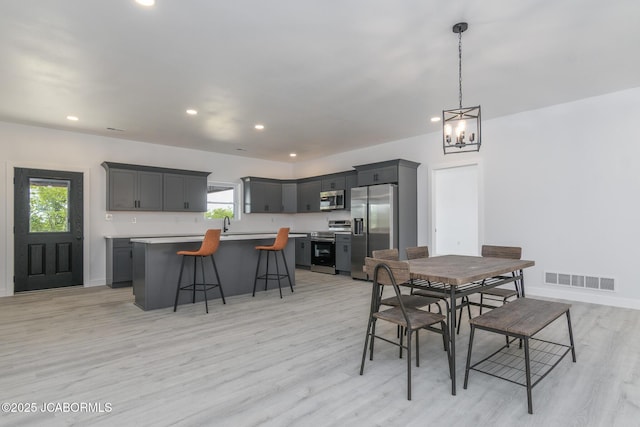 8206 Big Meadows Rd, Jefferson City, MO 65101 - dining space with light wood-style floors, a chandelier, recessed lighting, and baseboards