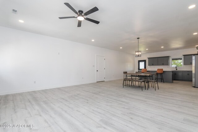 8206 Big Meadows Rd, Jefferson City, MO 65101 - dining room with light wood-style flooring, recessed lighting, a ceiling fan, baseboards, and a chandelier
