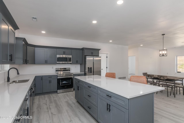 8206 Big Meadows Rd, Jefferson City, MO 65101 - kitchen featuring appliances with stainless steel finishes, a sink, light wood-style flooring, light countertops, and recessed lighting