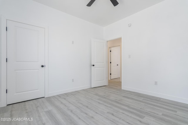 8206 Big Meadows Rd, Jefferson City, MO 65101 - unfurnished bedroom with wood finished floors, baseboards, and ceiling fan