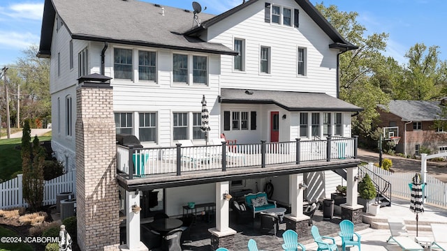 rear view of house featuring a patio, a balcony, central AC, and an outdoor hangout area