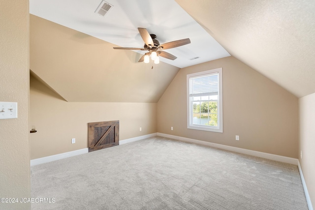 bonus room featuring light carpet, vaulted ceiling, and ceiling fan