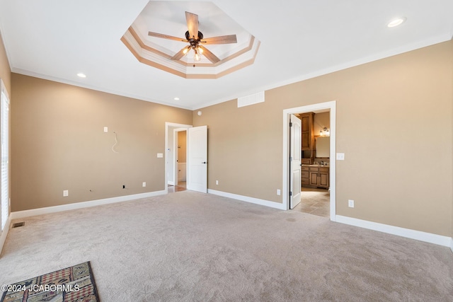 unfurnished bedroom featuring connected bathroom, light colored carpet, ceiling fan, and crown molding